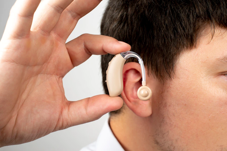 side view man wearing hearing aids 23 2149705953